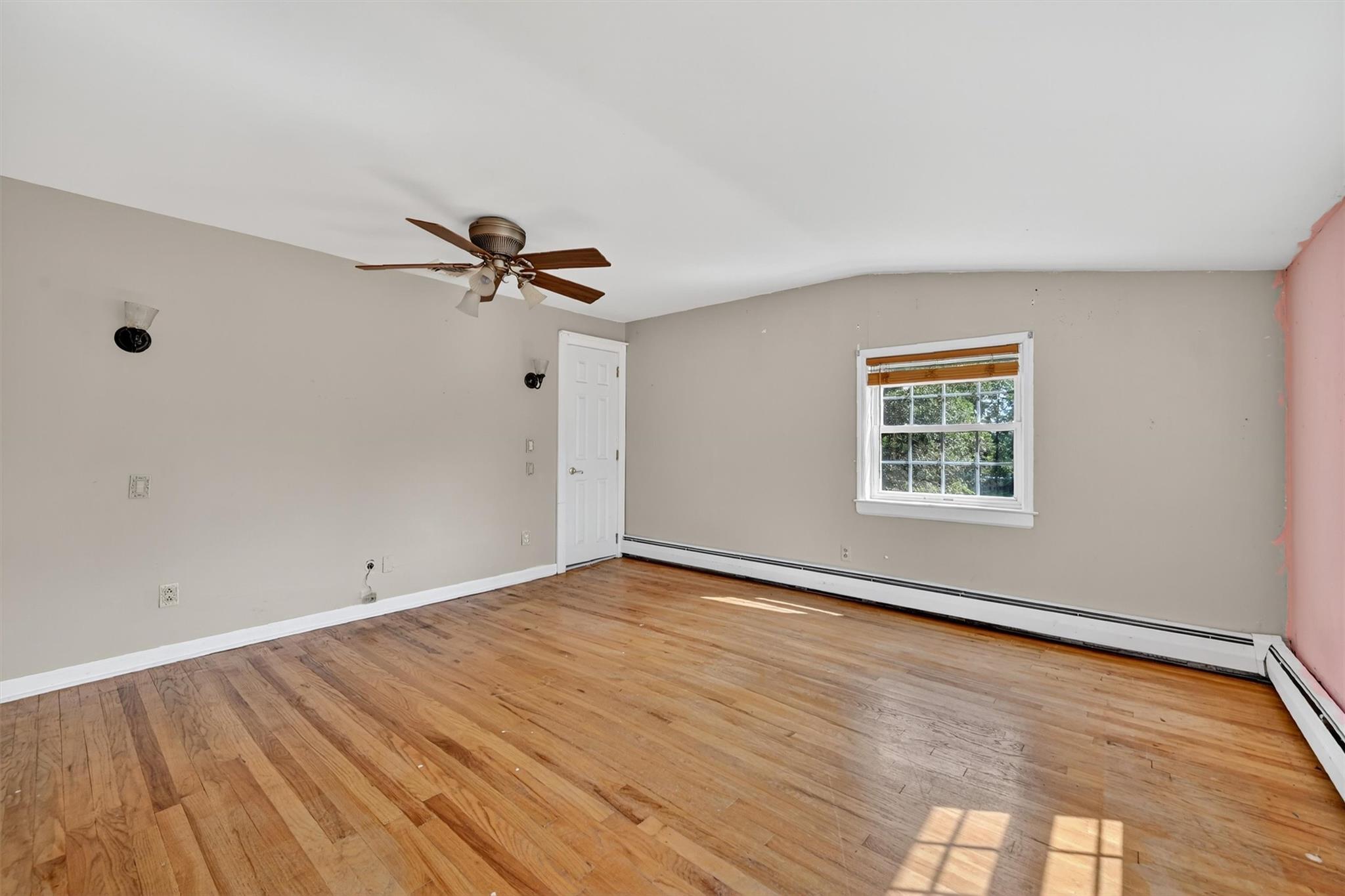 151 Tuthill Road Blooming Grove, NY 10914 - Photo 24 of 49 a view of an empty room with a window and wooden floor