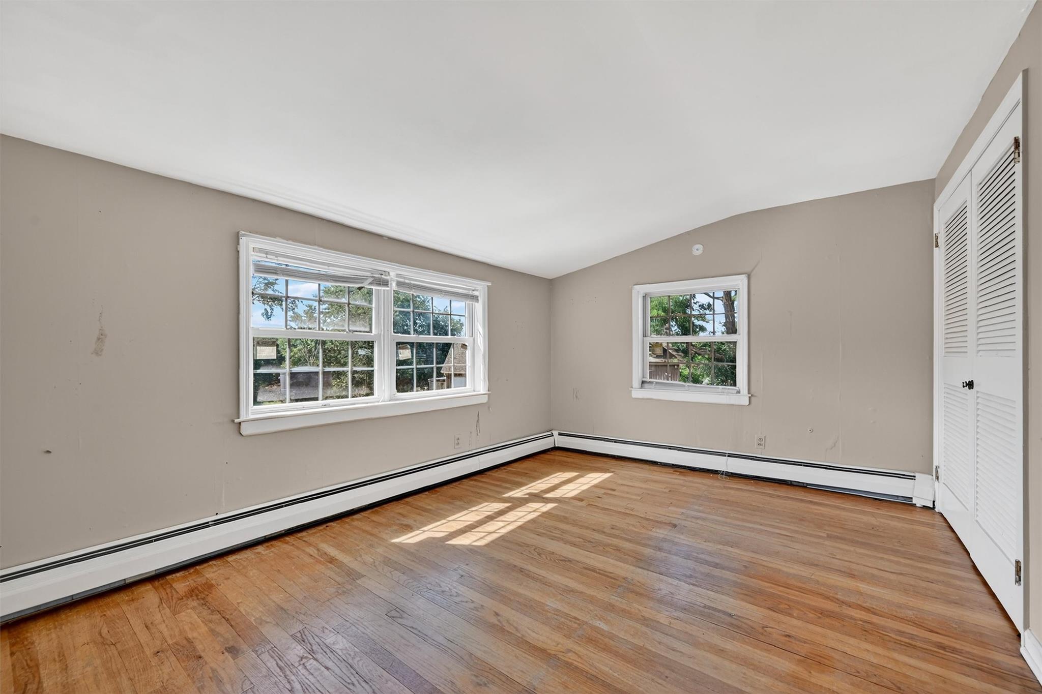 151 Tuthill Road Blooming Grove, NY 10914 - Photo 25 of 49 a view of an empty room with wooden floor and a window