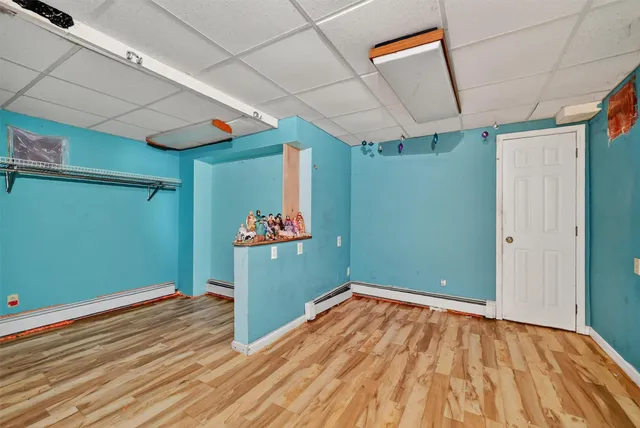 a view of a room with wooden floor