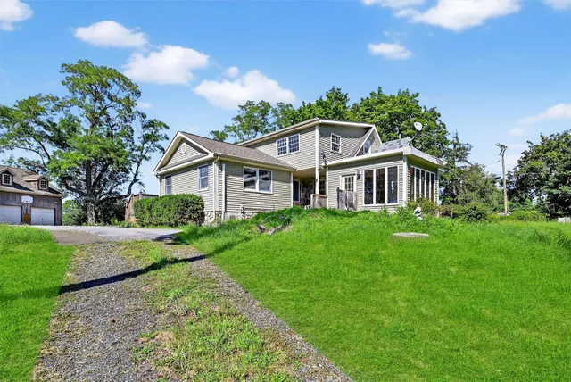 a view of green field with wooden fence