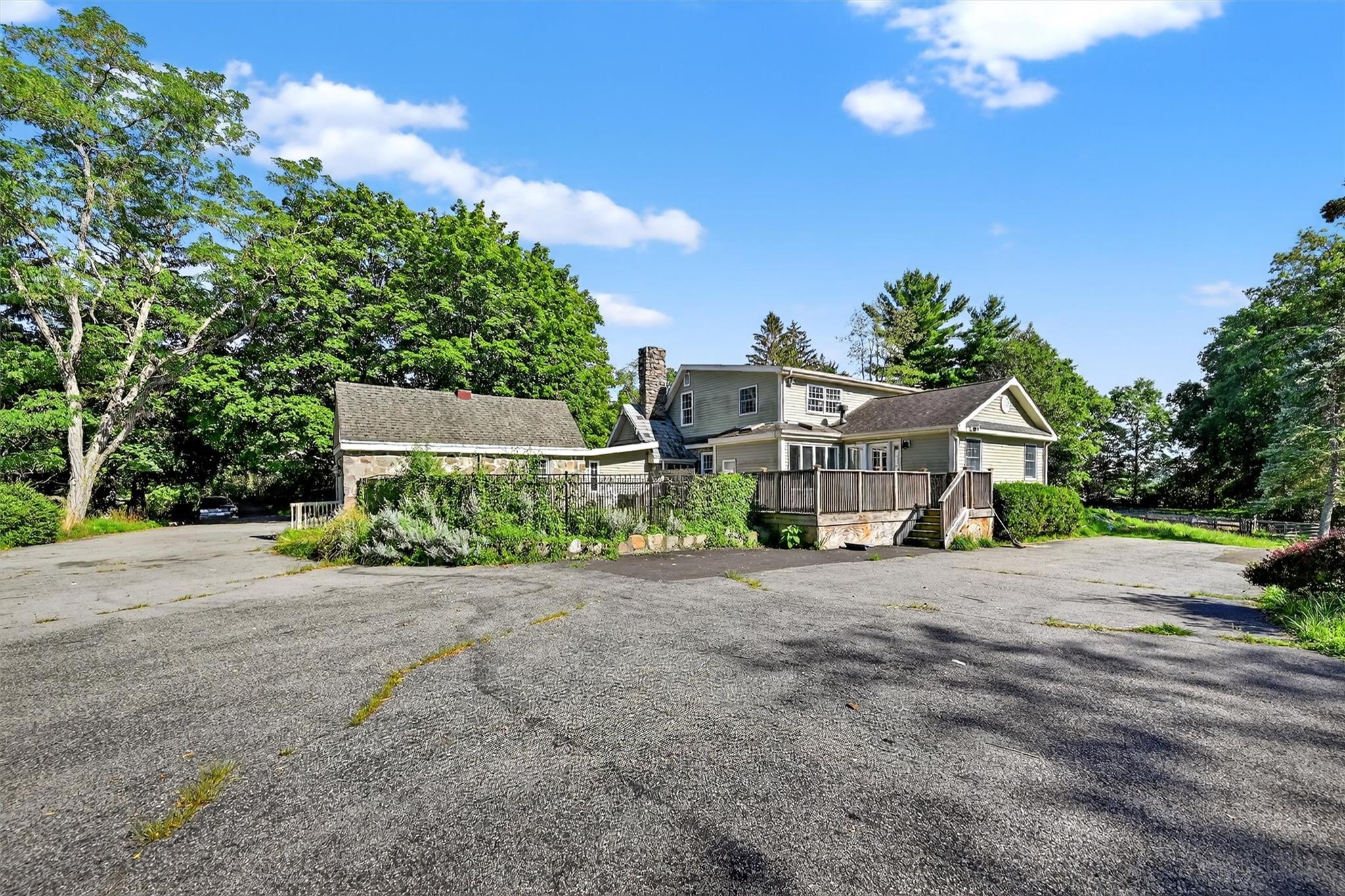 151 Tuthill Road Blooming Grove, NY 10914 - Photo 37 of 49 a front view of a house with a yard and garage
