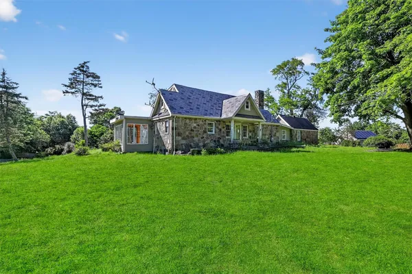 a view of an empty room with a fireplace and a window