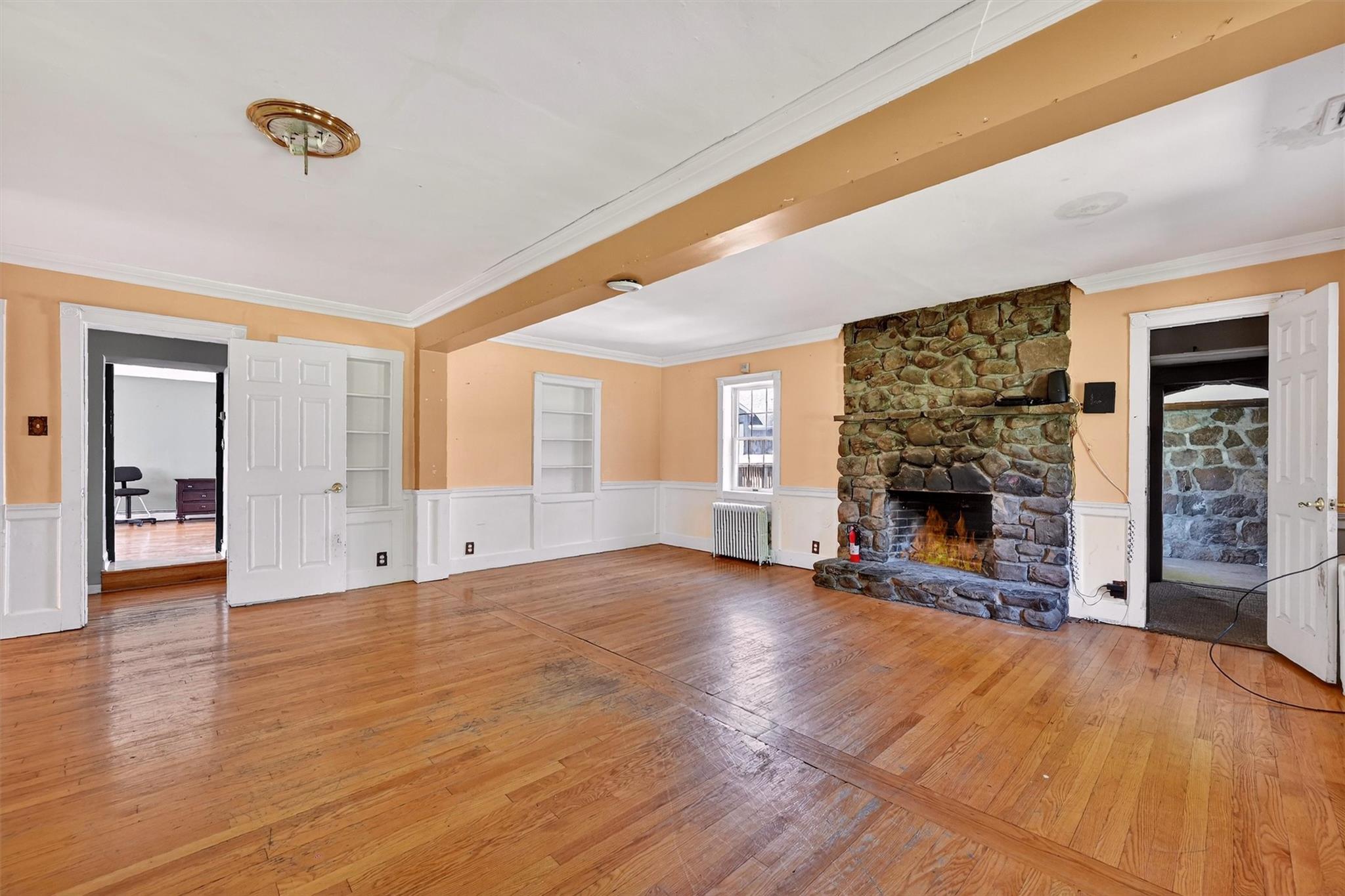 151 Tuthill Road Blooming Grove, NY 10914 - Photo 6 of 49 a view of an empty room with a fireplace and a window