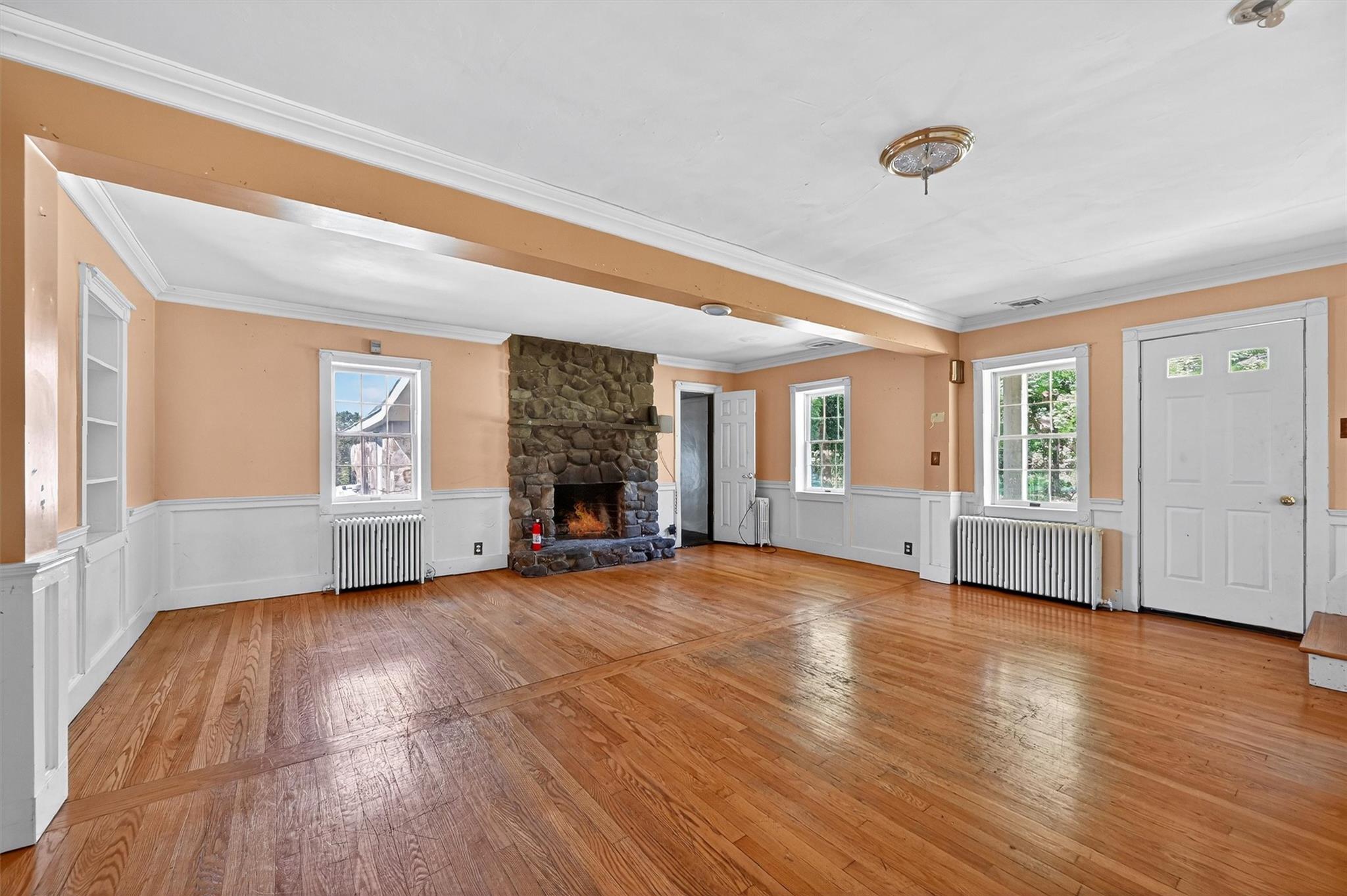 151 Tuthill Road Blooming Grove, NY 10914 - Photo 7 of 49 an empty room with wooden floor and windows