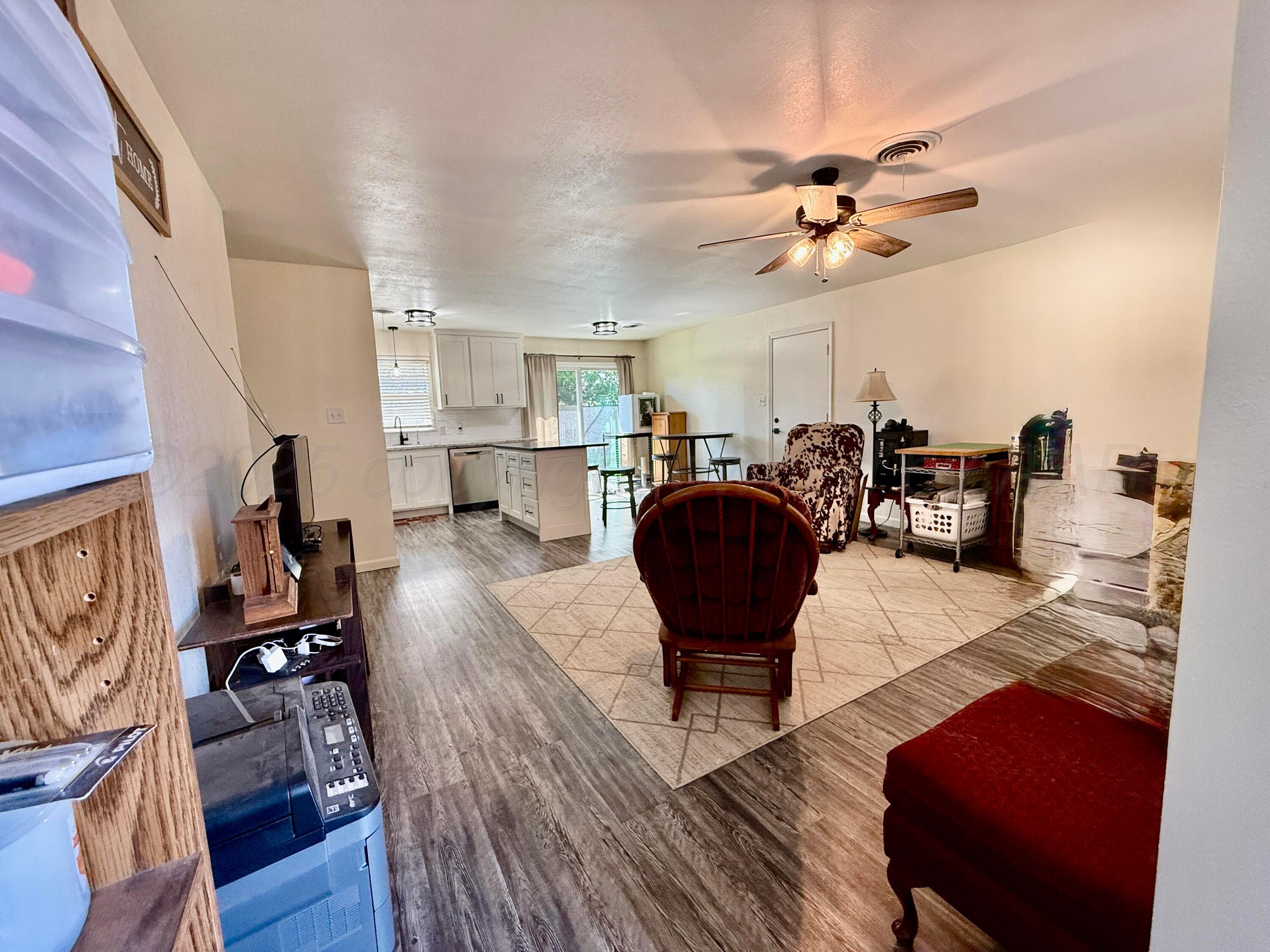 4600 South Bryan Street Amarillo, TX 79110 - Photo 5 of 13 a living room with furniture and a wooden floor