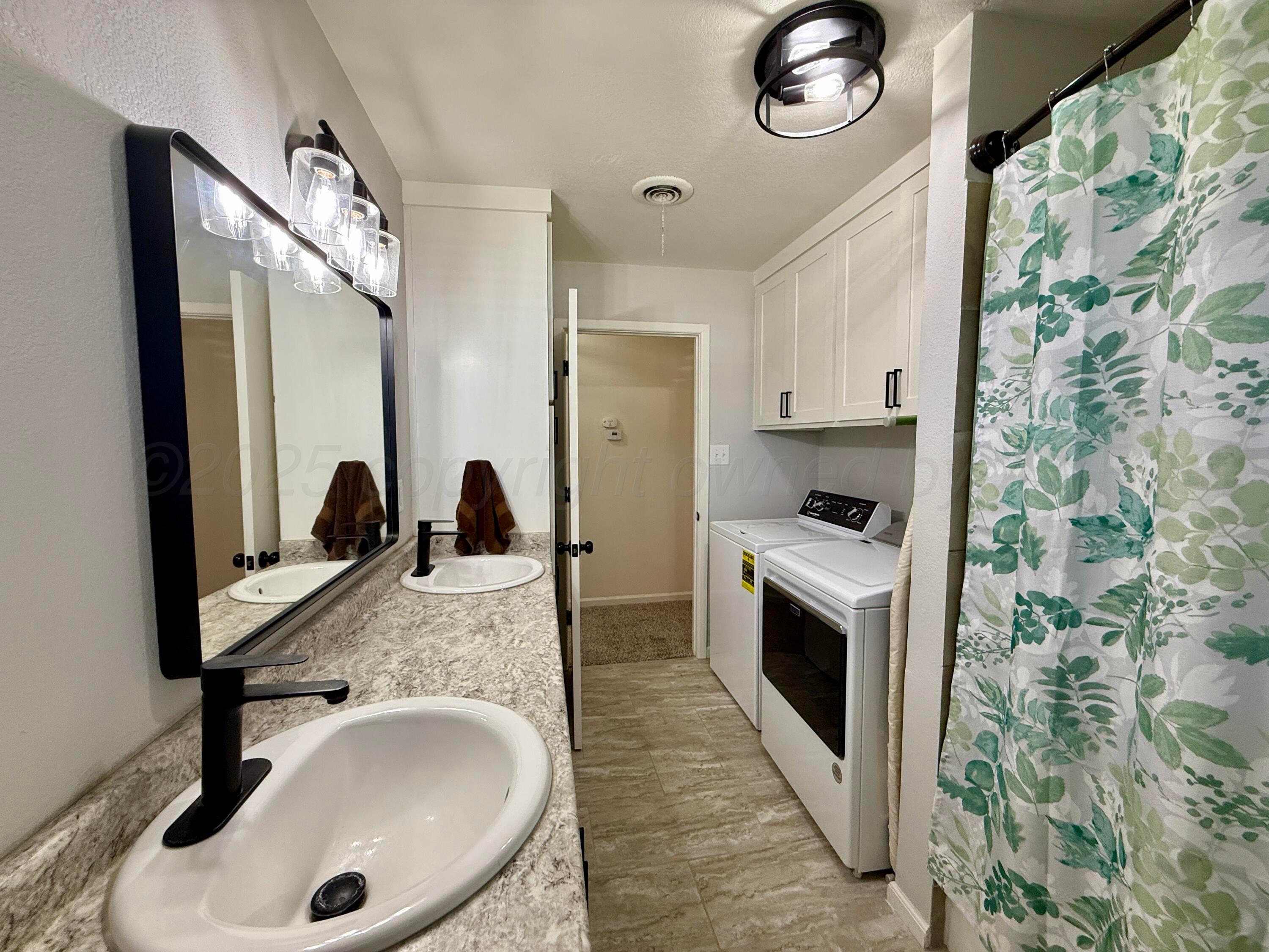 4600 South Bryan Street Amarillo, TX 79110 - Photo 6 of 13 a en suite bathroom with a granite countertop double vanity sink and mirror