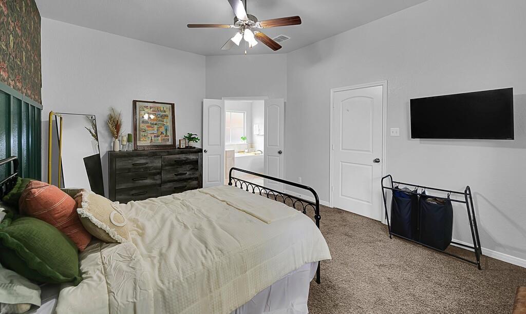 2720 Beutel Road Lorena, TX 76655 - Photo 17 of 37 Carpeted bedroom with ceiling fan and ensuite bathroom