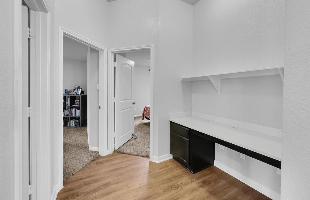 2720 Beutel Road Lorena, TX 76655 - Photo 26 of 37 Bar area with light wood finished floors, light colored carpet, and dark cabinetry