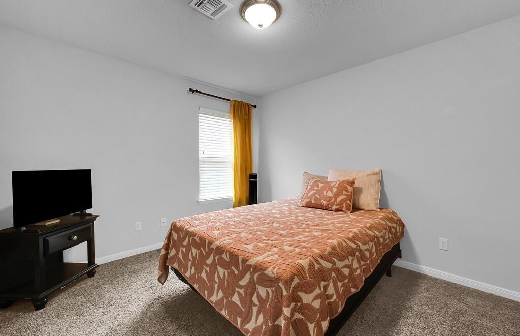 2720 Beutel Road Lorena, TX 76655 - Photo 28 of 37 Carpeted bedroom featuring baseboards and a textured ceiling