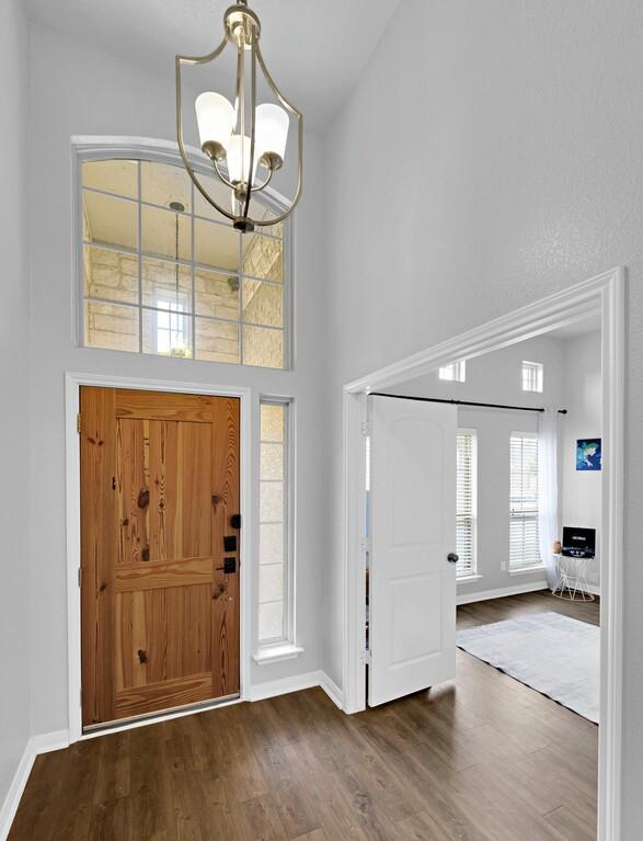 2720 Beutel Road Lorena, TX 76655 - Photo 4 of 37 Entrance foyer featuring a towering ceiling, wood finished floors, and a chandelier