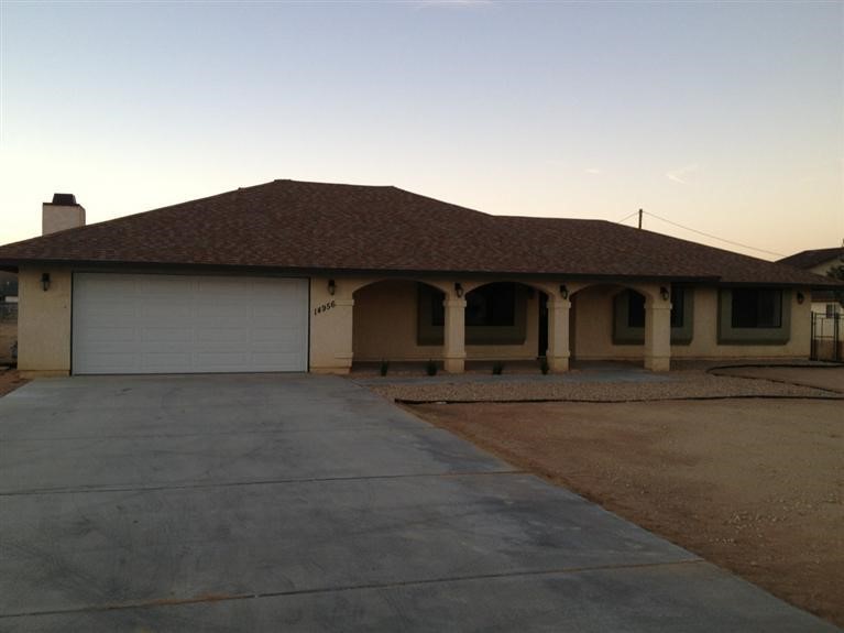14956 Cheyenne Road Apple Valley, CA 92307 - Photo 1 of 1 a front view of a house with a garden