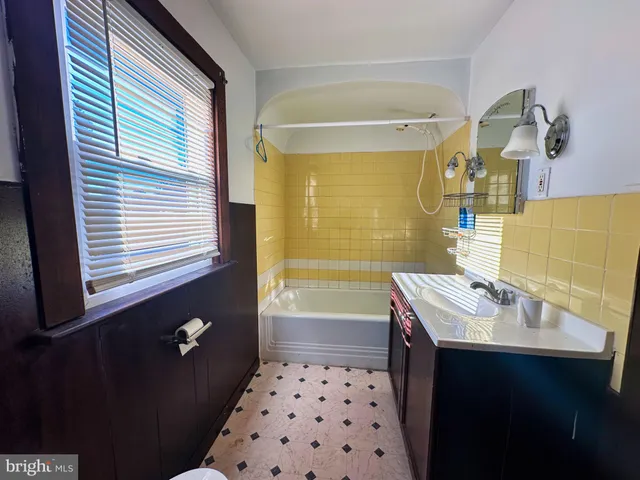 a bathroom with a sink vanity and a mirror