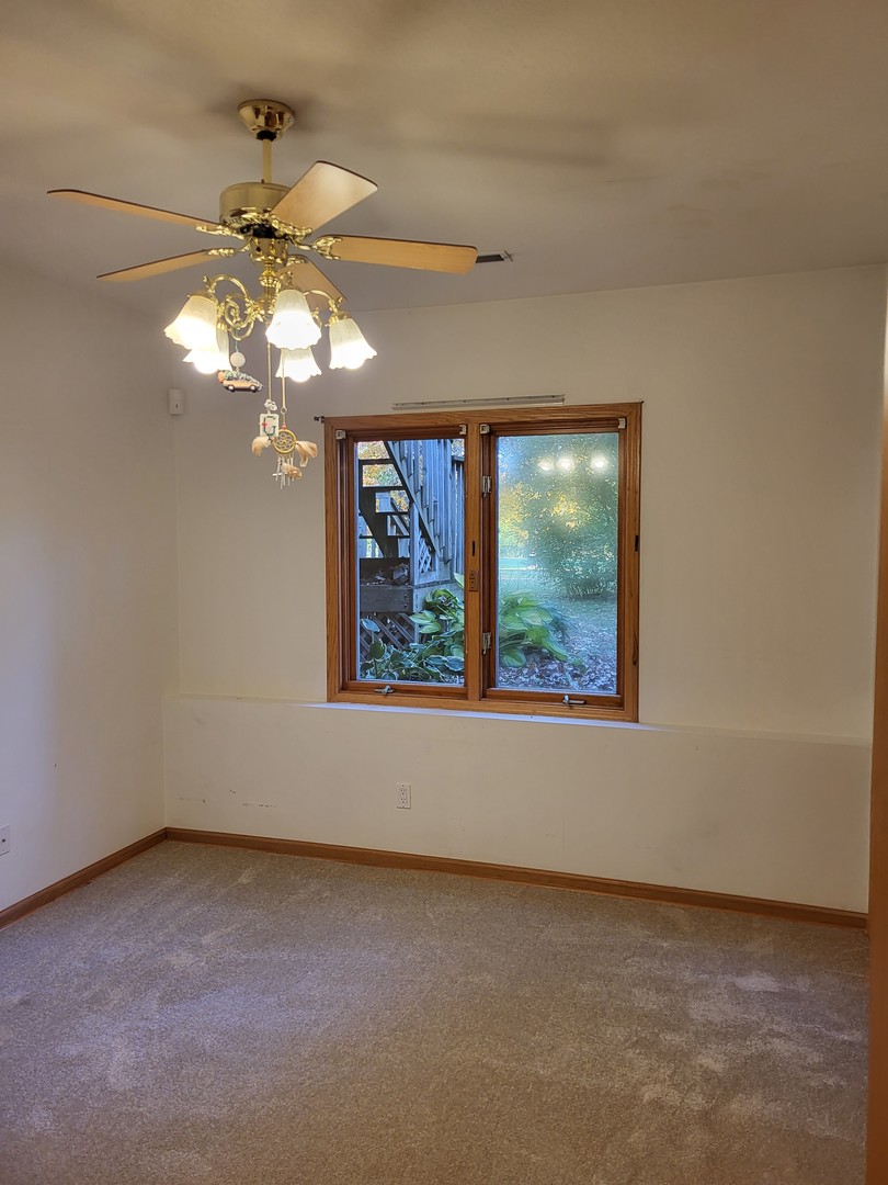 10120 East Hickory Ridge Drive Rochelle, IL 61068 - Photo 35 of 39 a view of a room that has a window and a chandelier