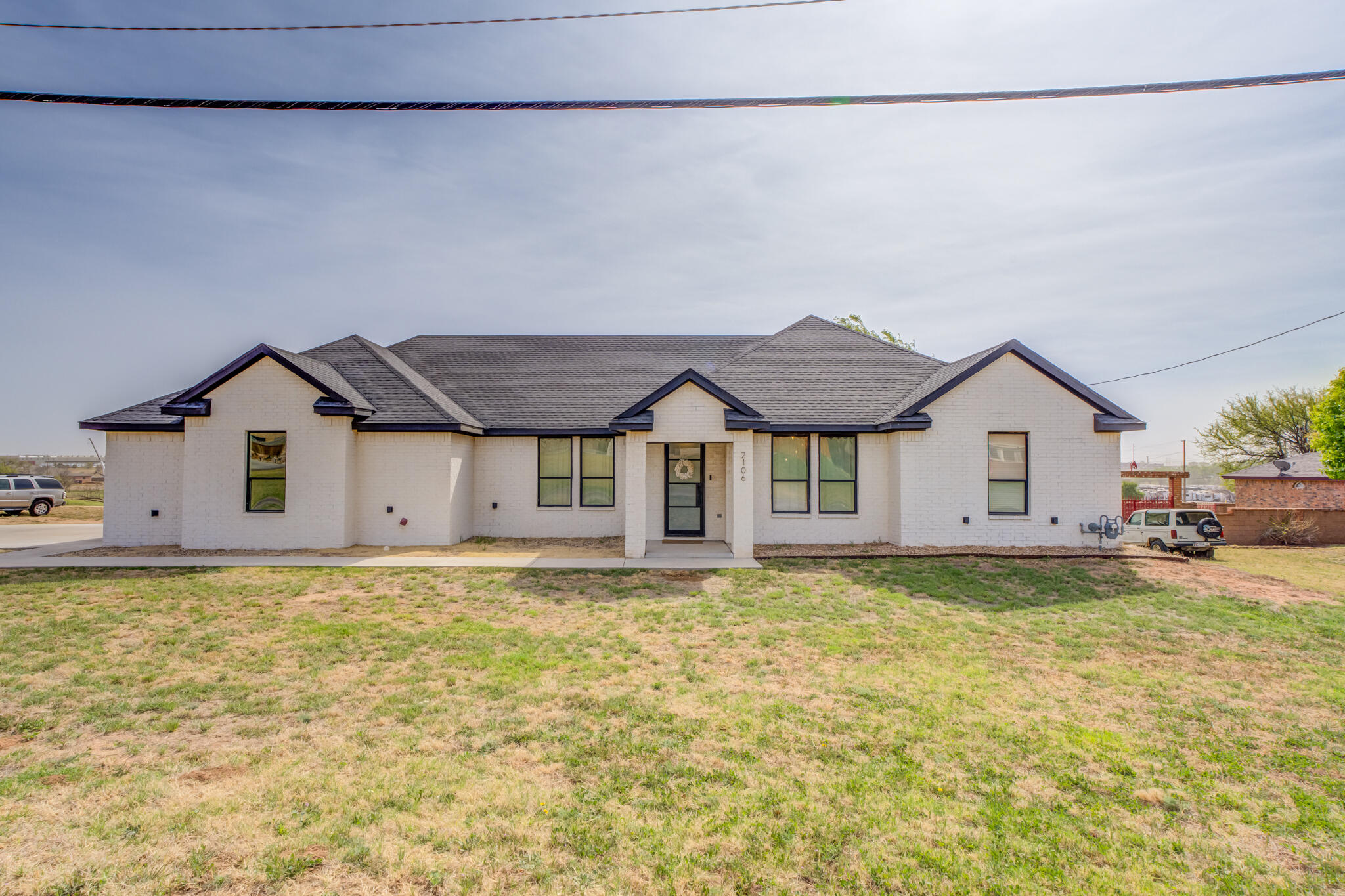 2106 Mesa Road Lubbock, TX 79403 - Photo 1 of 42 a view of a house with a yard and large tree