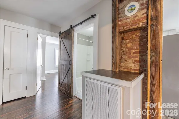 a hallway with front door wooden floor and windows