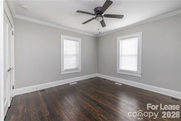a view of an empty room with wooden floor