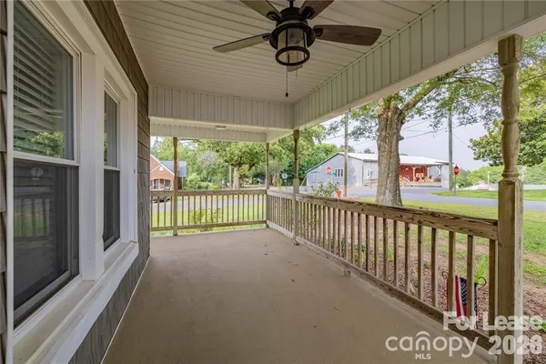 a view of a porch with wooden floor
