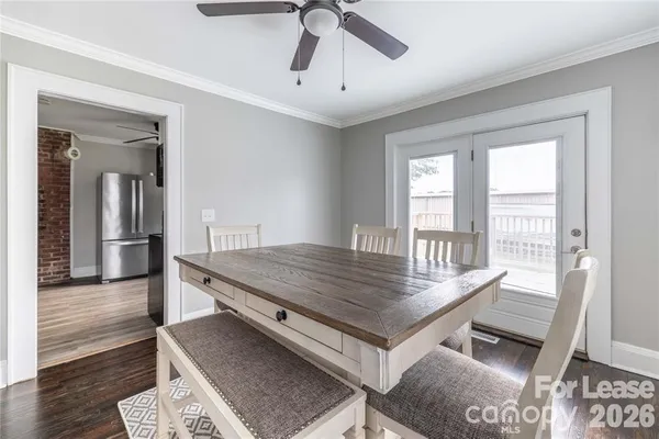 a dining room with wooden floor and window