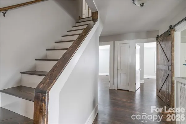 a view of entryway and hall with wooden floor