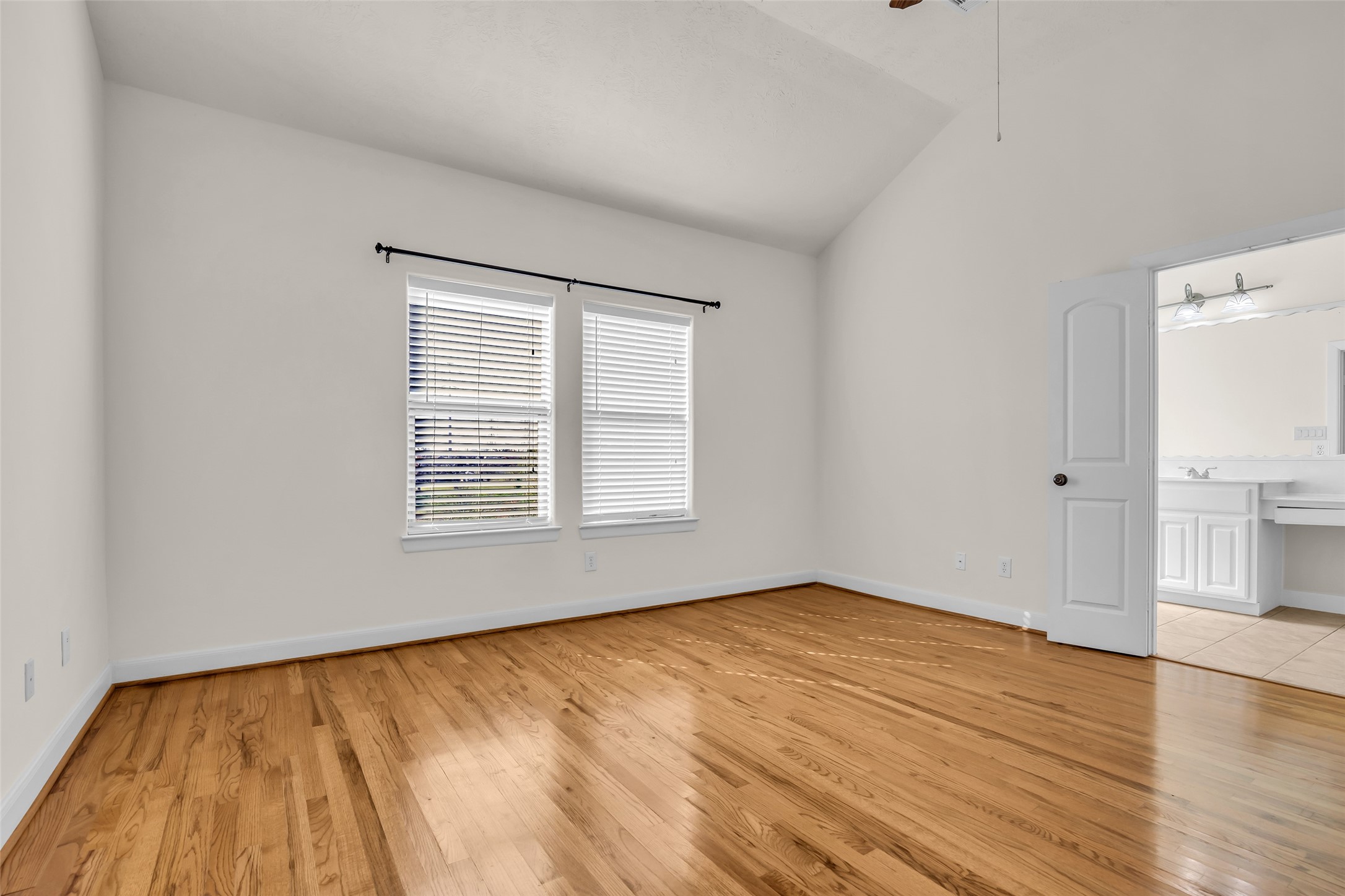 1803 Stacy Crest Houston, TX 77008 - Photo 17 of 28 The primary bedroom offers a spacious layout with wooden floors, plenty of natural light, and an attached primary bathroom.