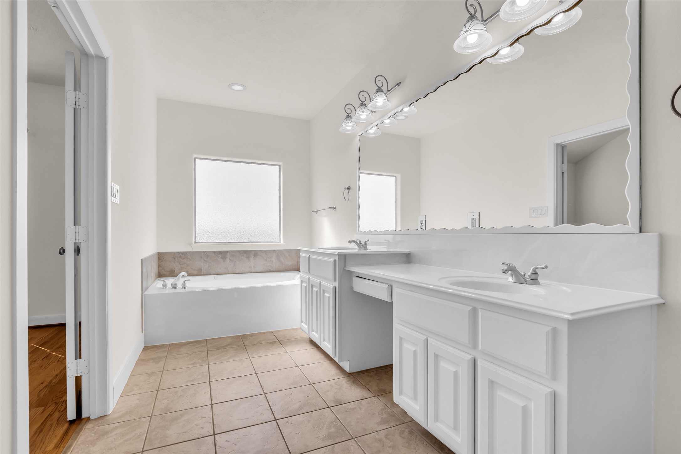 1803 Stacy Crest Houston, TX 77008 - Photo 19 of 28 This full bathroom is bright and features a large vanity mirror, providing a functional and well-lit space.