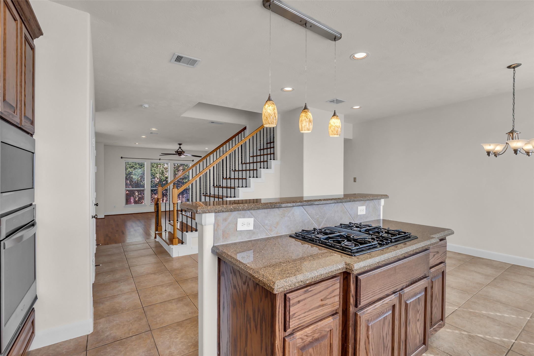 1803 Stacy Crest Houston, TX 77008 - Photo 10 of 28 The kitchen island includes a gas cooktop and an additional area designed for use as a breakfast bar.