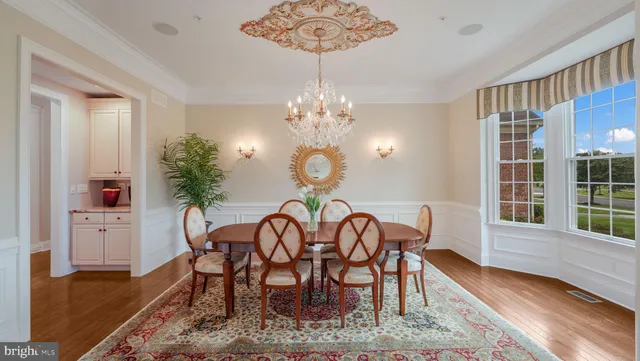 a kitchen with stainless steel appliances granite countertop a kitchen island a stove a table and chairs in it