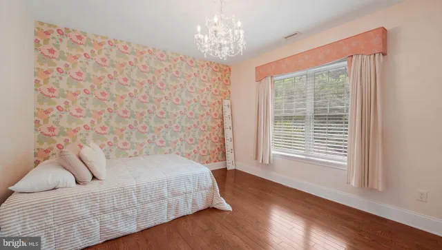 a view of backyard with a car parked in it