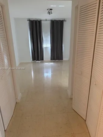 an empty room with wooden floor