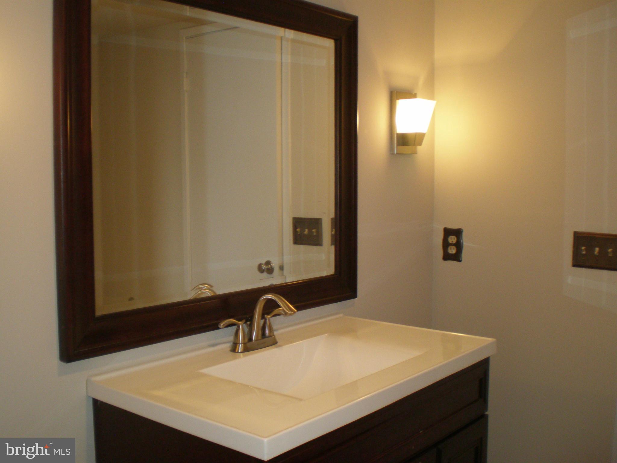 6101 Edsall Road, Unit 1412 Alexandria, VA 22304 - Photo 12 of 17 a bathroom with a sink vanity and a mirror