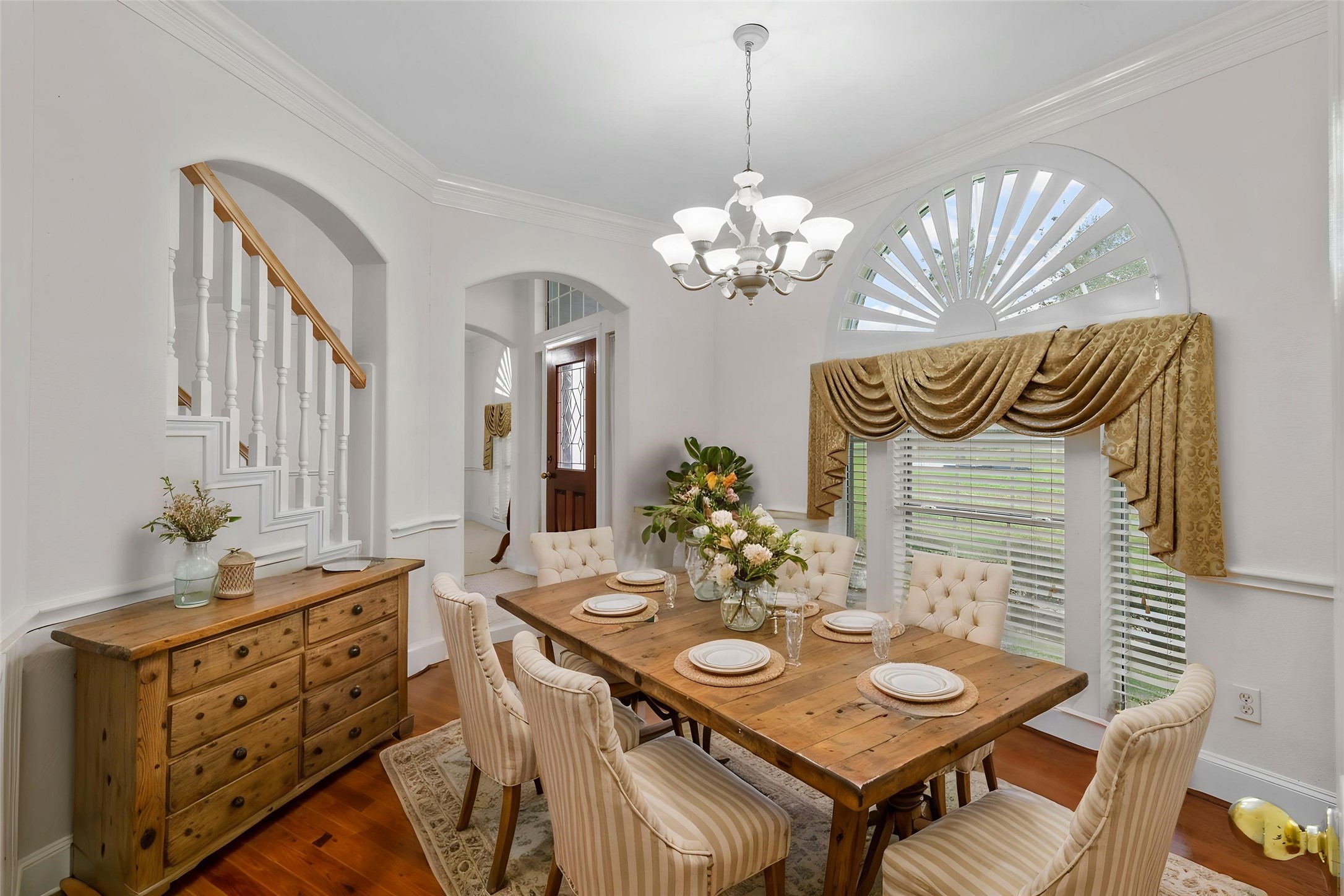 10302 Hanselman Road, Unit CR69 Manvel, TX 77578 - Photo 20 of 49 a view of a dining room with furniture a chandelier and wooden floor