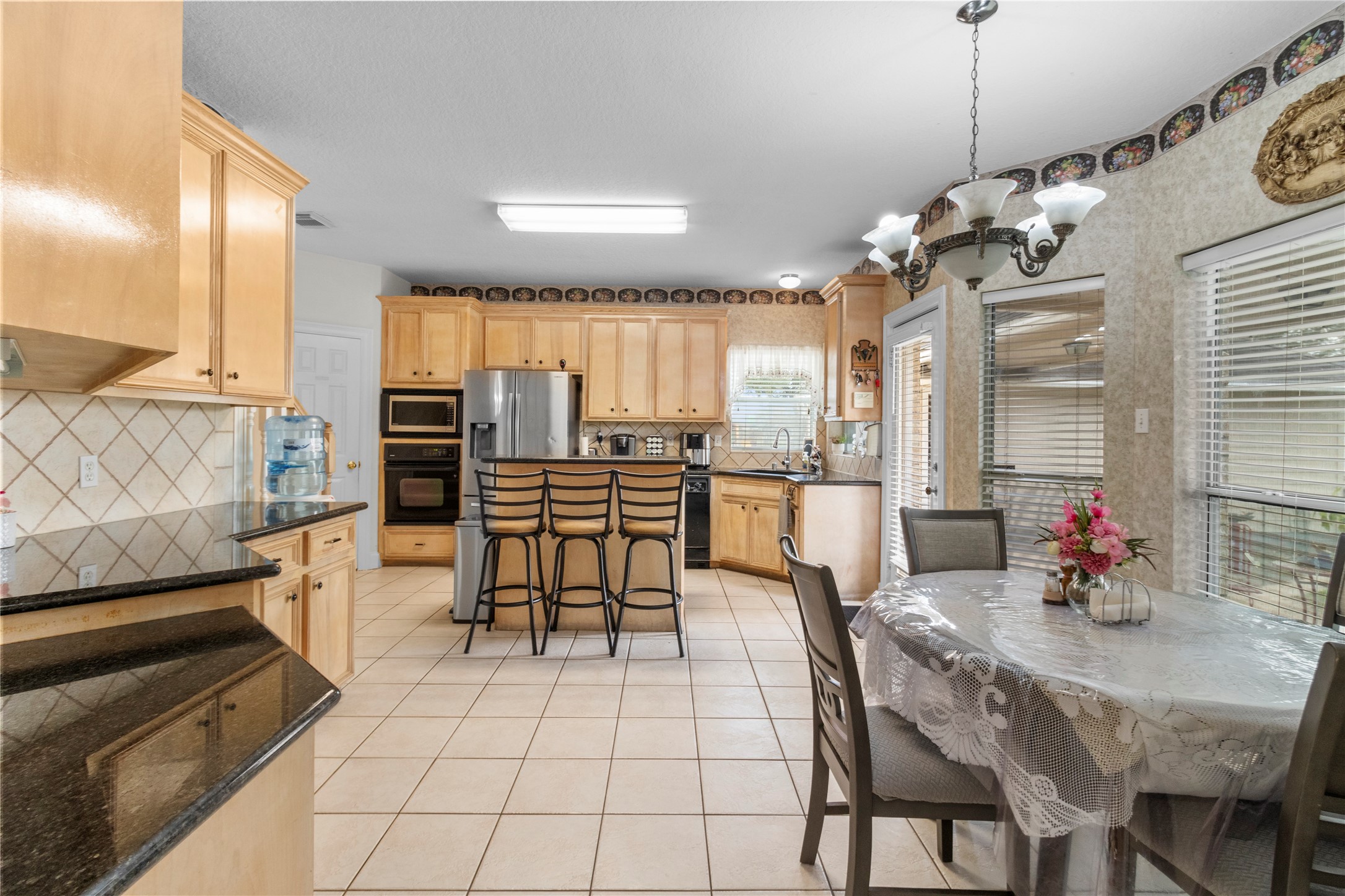 10302 Hanselman Road, Unit CR69 Manvel, TX 77578 - Photo 28 of 49 a view of a dining room with furniture and chandelier