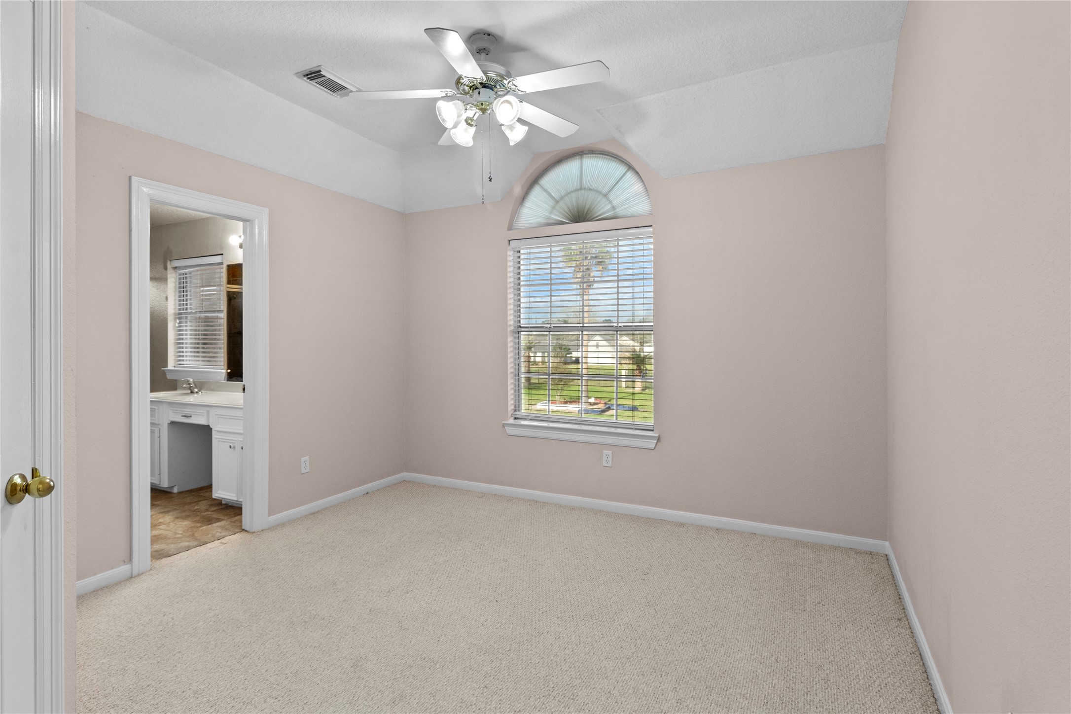 10302 Hanselman Road, Unit CR69 Manvel, TX 77578 - Photo 36 of 49 an empty room with windows and ceiling fan
