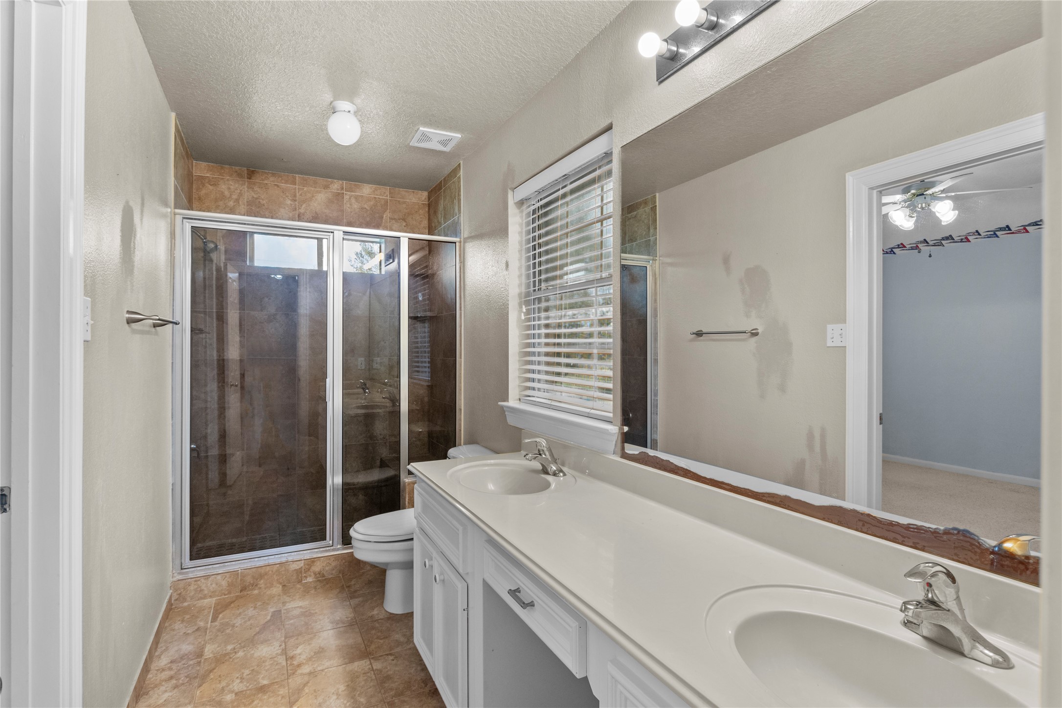 10302 Hanselman Road, Unit CR69 Manvel, TX 77578 - Photo 37 of 49 a bathroom with a sink a toilet and shower