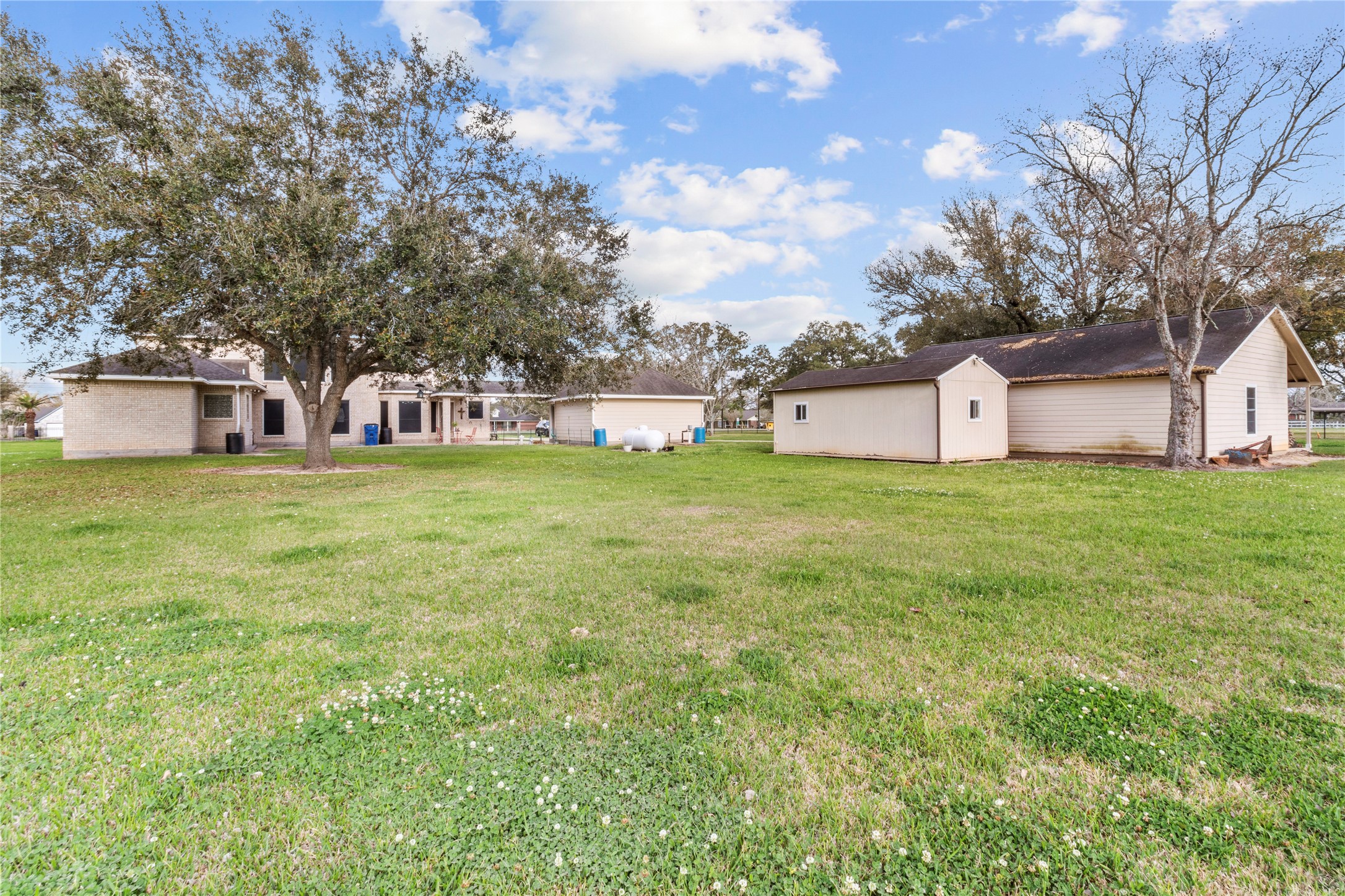 10302 Hanselman Road, Unit CR69 Manvel, TX 77578 - Photo 10 of 49 a view of a house with a big yard and large trees