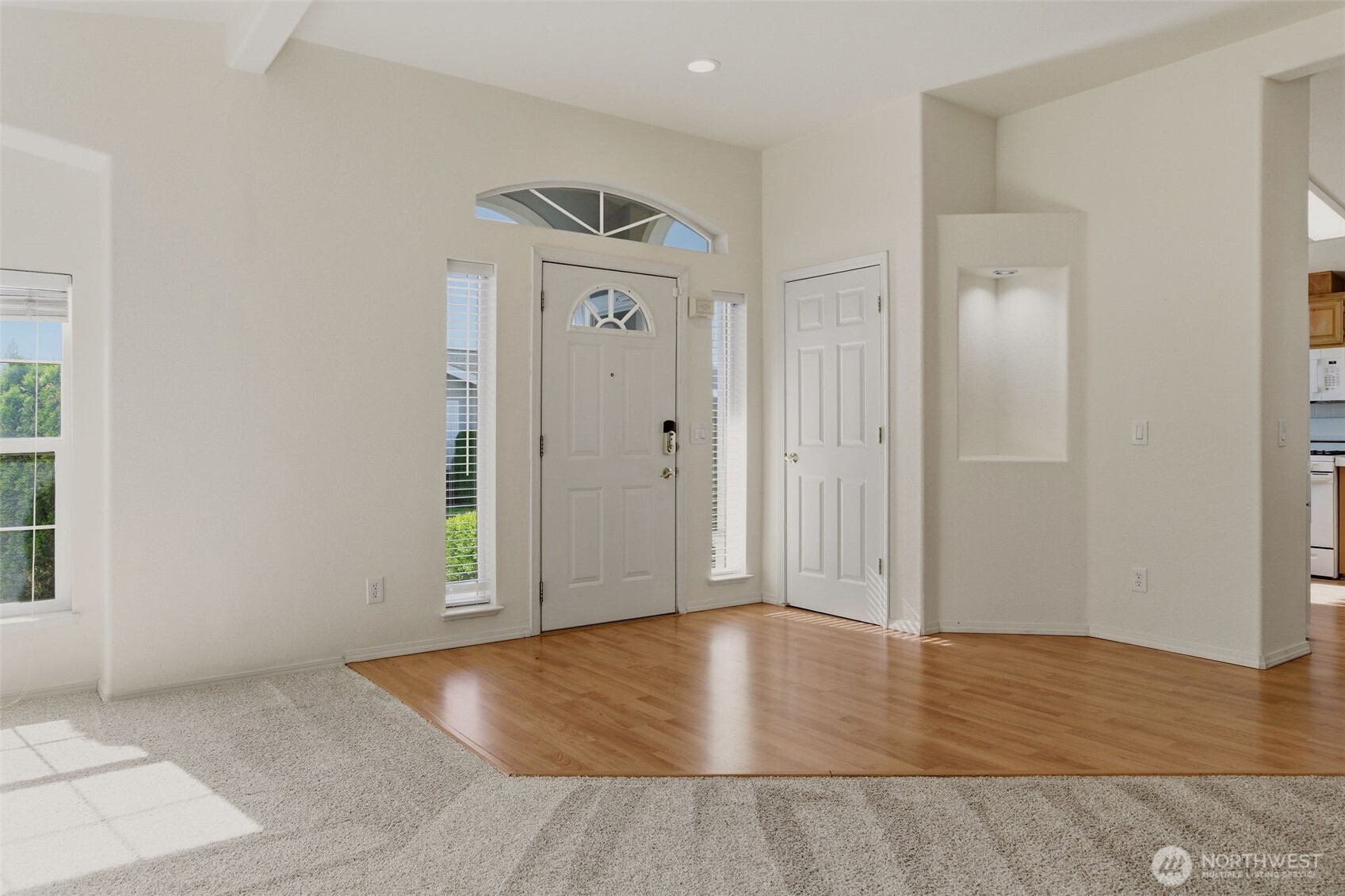 24036 222nd Avenue Southeast Maple Valley, WA 98038 - Photo 5 of 37 an empty room with wooden floor and windows