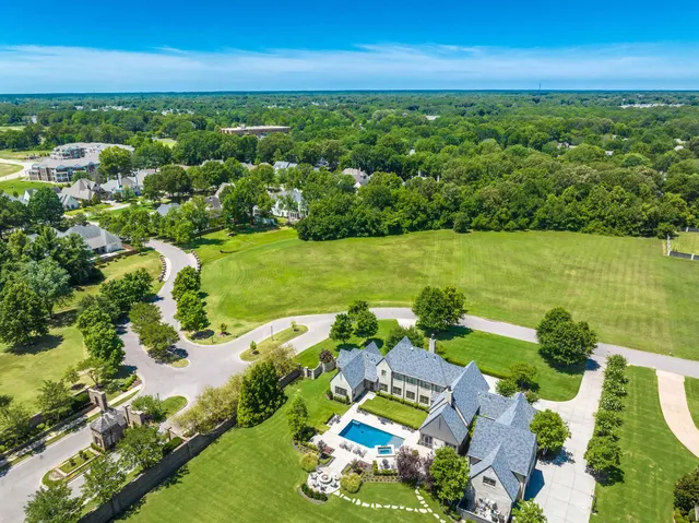 an aerial view of a houses with a yard