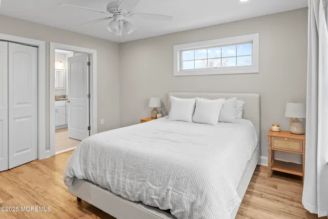 a living room with furniture kitchen view and a wooden floor