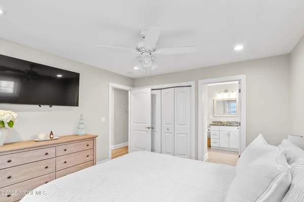 a bathroom with a granite countertop sink a toilet and a mirror