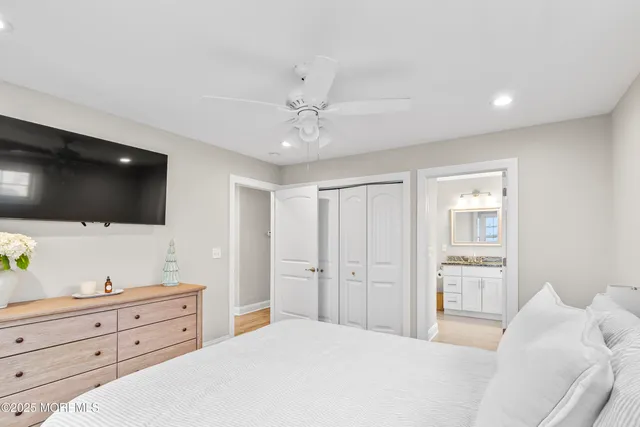 a bathroom with a granite countertop sink a toilet and a mirror