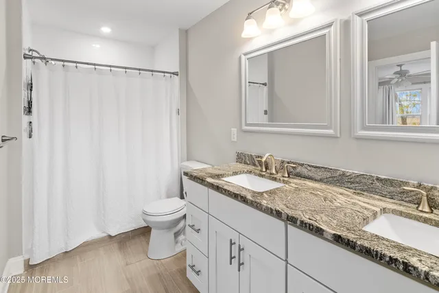 a kitchen that has a lot of cabinets furniture and stainless steel appliances