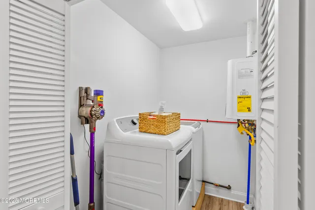 a kitchen with stainless steel appliances a microwave a stove a sink dishwasher a refrigerator with a dining table and chairs