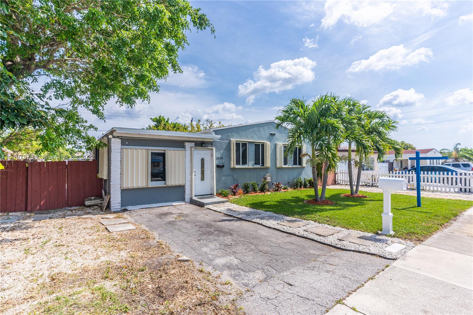 2123 Funston Street Hollywood, FL 33020 - Photo 23 of 30 a front view of a house with a yard and trees