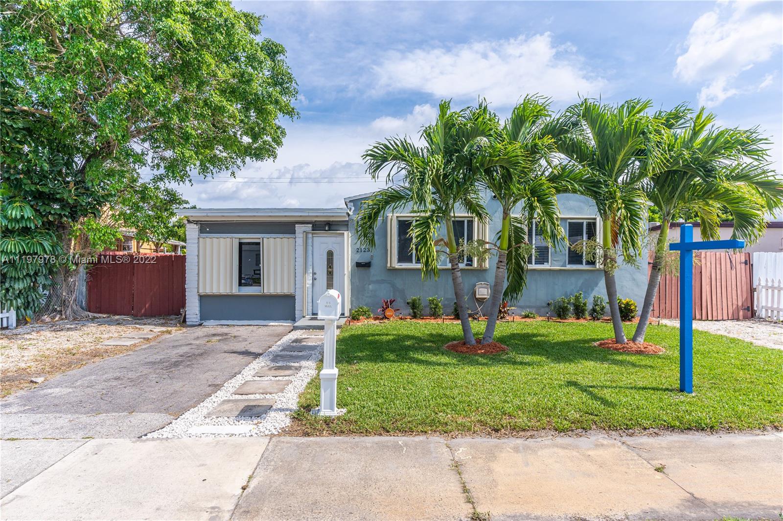2123 Funston Street Hollywood, FL 33020 - Photo 28 of 30 a front view of house with yard and green space