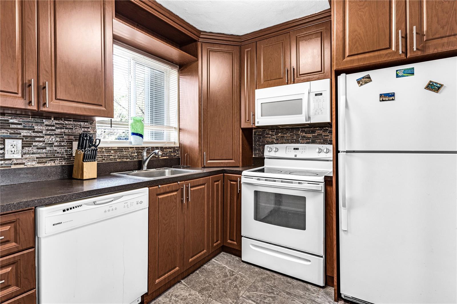 2123 Funston Street Hollywood, FL 33020 - Photo 5 of 30 a kitchen with granite countertop white cabinets and white appliances
