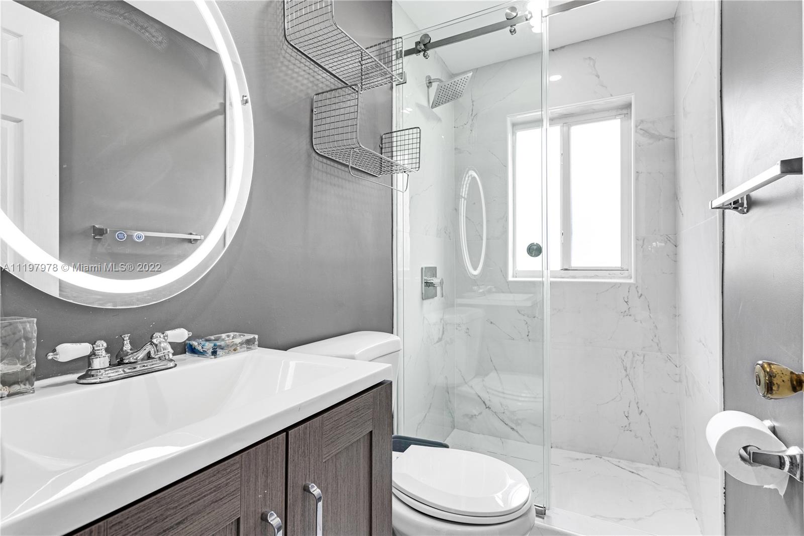 2123 Funston Street Hollywood, FL 33020 - Photo 6 of 30 a bathroom with a sink a toilet and shower