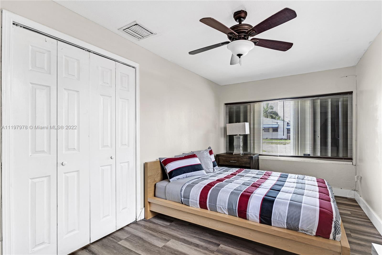 2123 Funston Street Hollywood, FL 33020 - Photo 8 of 30 a bedroom with a large bed and a chandelier