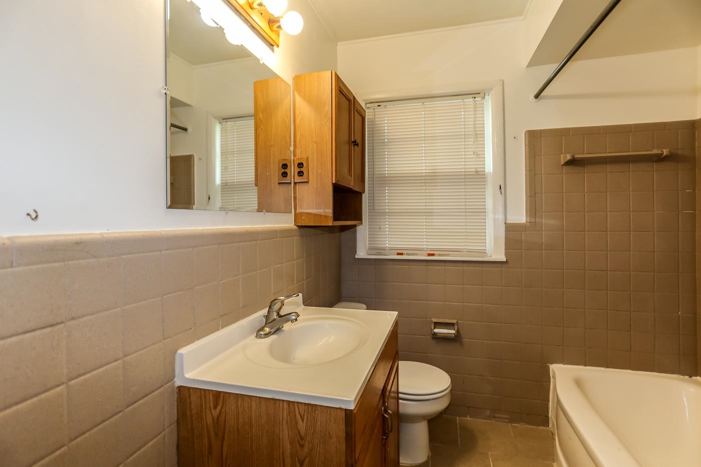 4705 Owen Road Memphis, TN 38122 - Photo 13 of 18 a bathroom with a sink a toilet and mirror