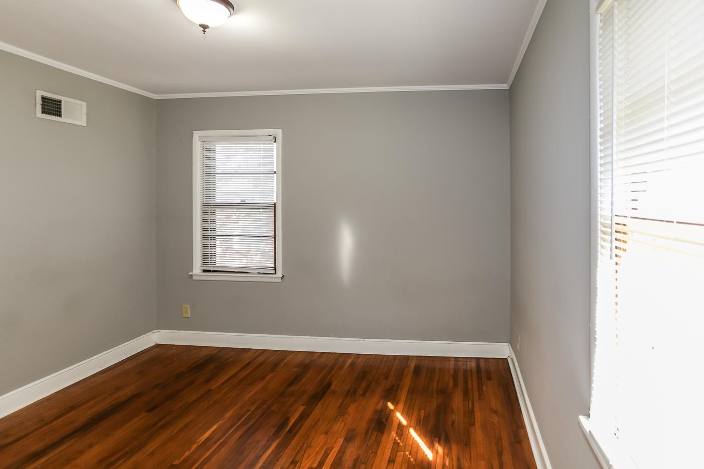 4705 Owen Road Memphis, TN 38122 - Photo 16 of 18 an empty room with wooden floor and windows