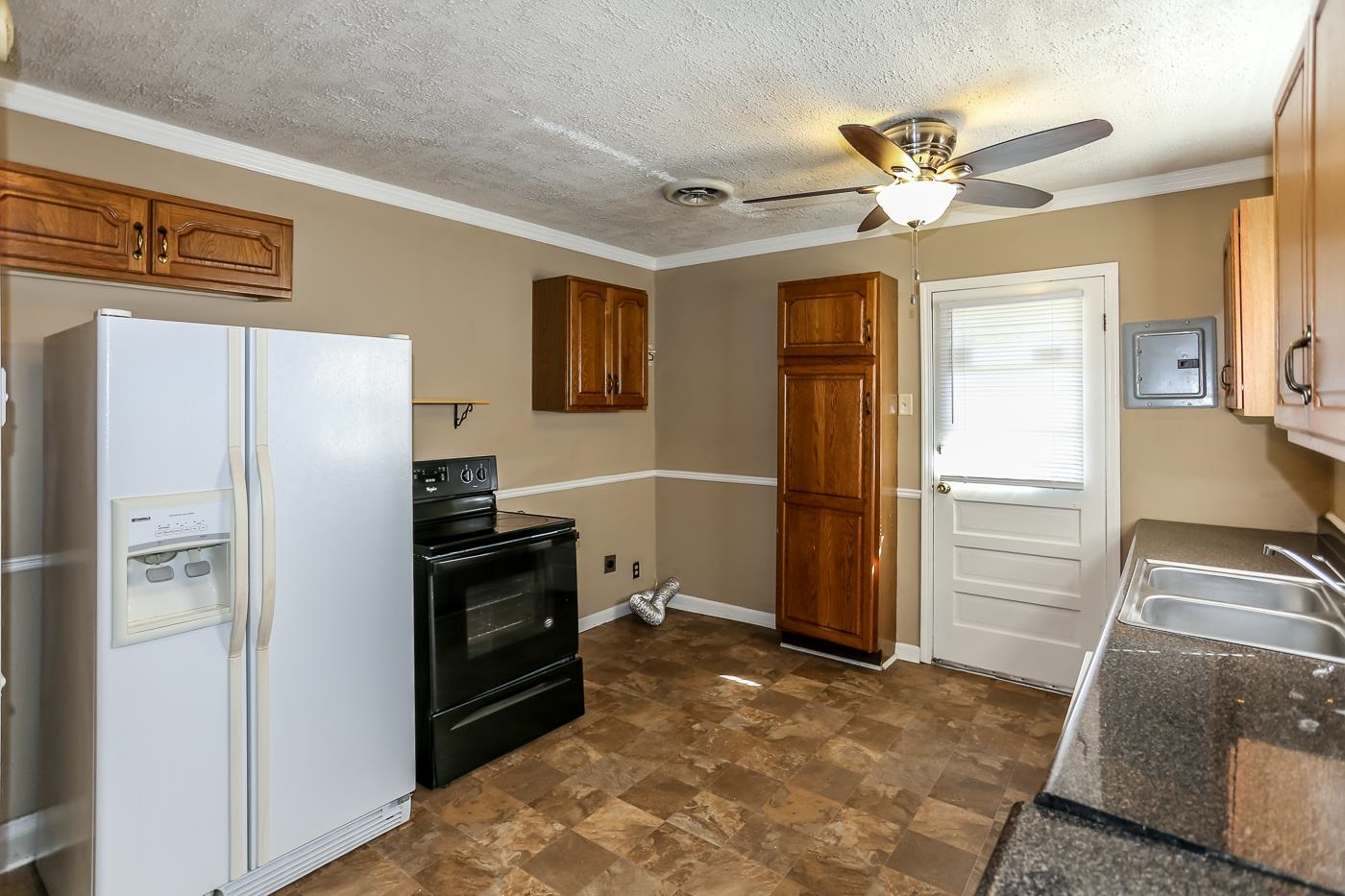 4705 Owen Road Memphis, TN 38122 - Photo 10 of 18 a kitchen with a refrigerator and a stove top oven